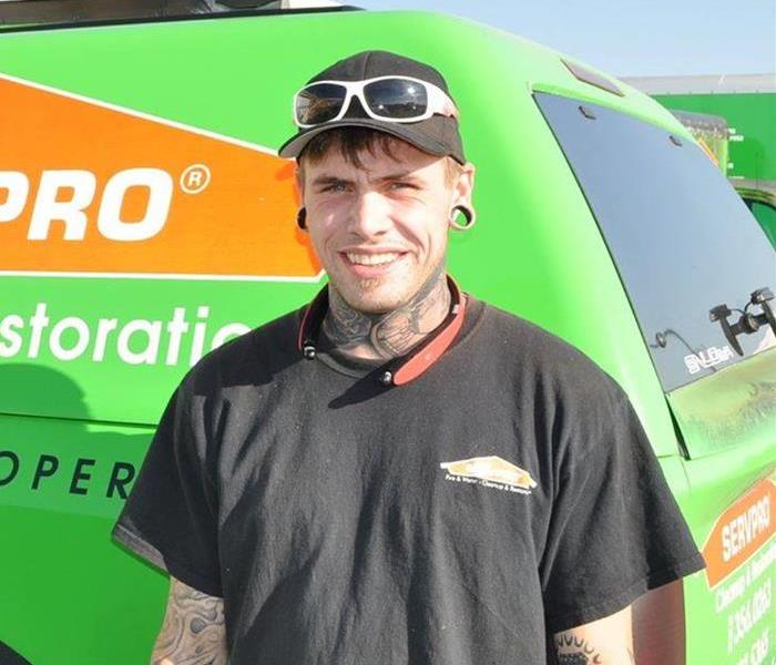 One of our crew chiefs Zach standing in front of a SERVPRO truck